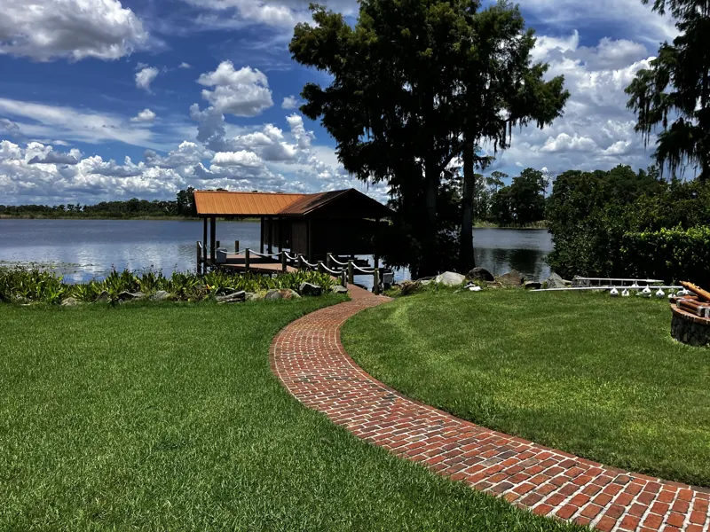 Brick path down to a lakefront boathouse