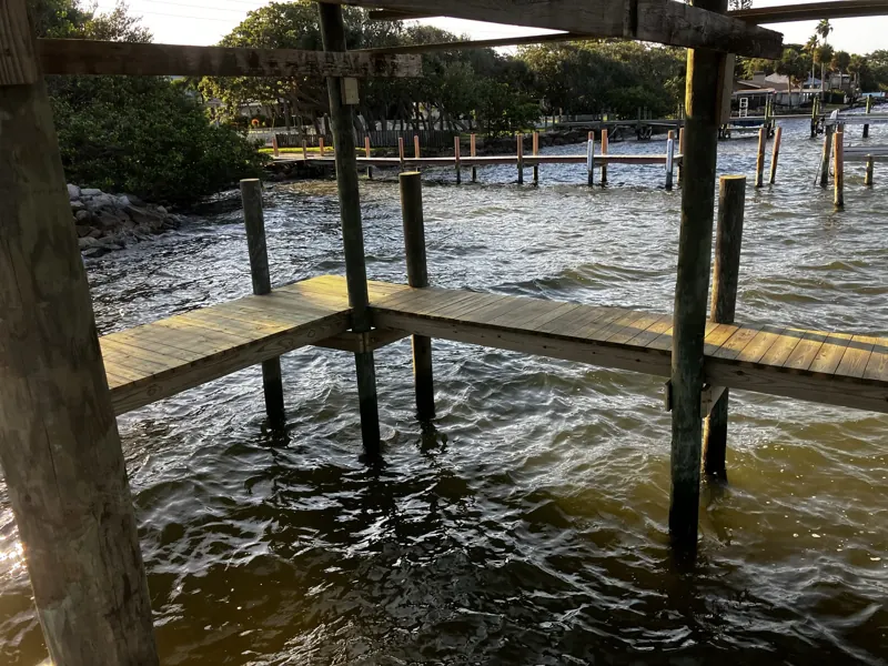 Dock framing and pilings over open water